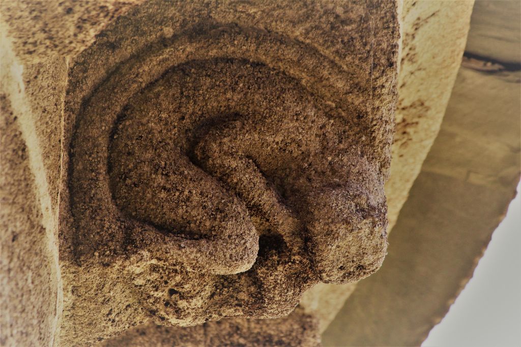 Romański kościół w San Miguel de Bacurin. Skorodowana postać na granitowym kroksztynie podtrzymującym gzyms apsydy. Fot. Jerzy S. Majewski
